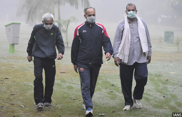 Gurugram: People wear masks to protect themselves as the levels of pollution increased in Gurugram on Nov 8, 2017. (Photo: IANS)