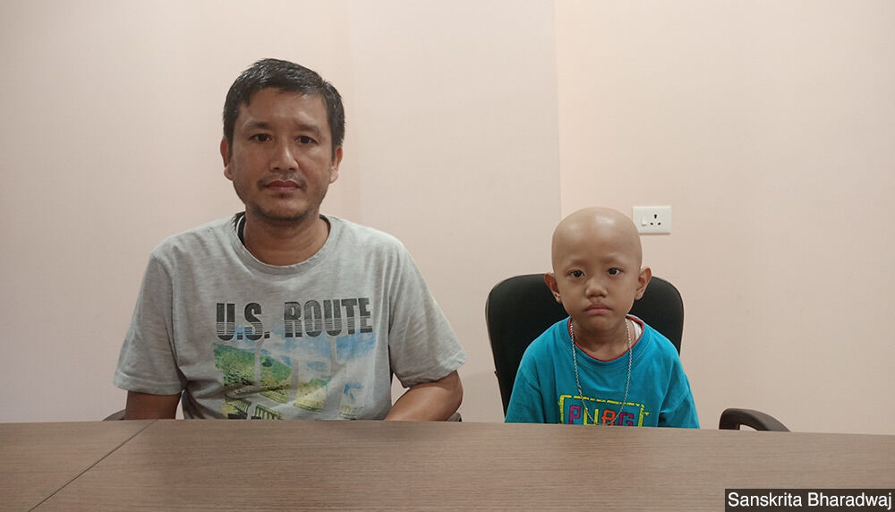Lalchemla Singh with his son Kiran Singh. Kiran was diagnosed with small cell tumour. They travelled from Manipur to Assam for treatment.