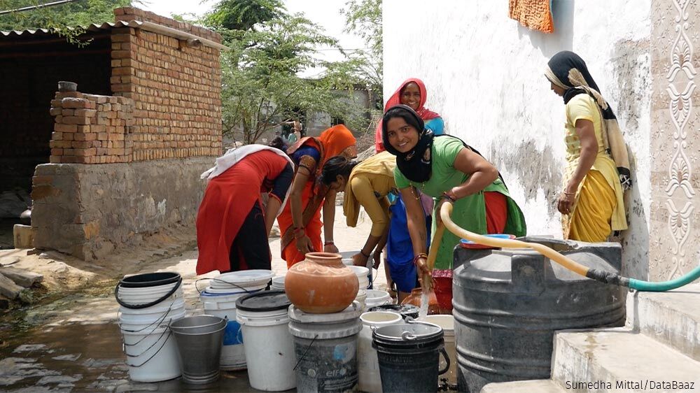 Women in Bibipur village filling water from a neighbour's tap. Only 22% of households in the Mewat region of Haryana get treated water supply, according to the Niti Aayog. Women in the district spend between 3.5 and 5 hours a day collecting water.