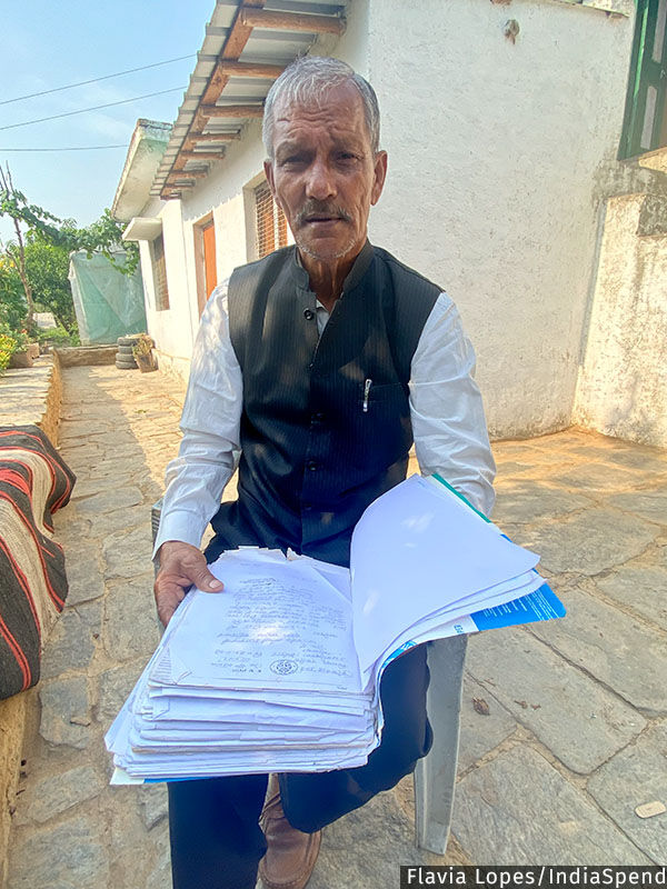 Govind Singh Bisht, 67, from Ghargaon village, with his file that includes complaint letters and documents from the 1990s about Van Panchayats.