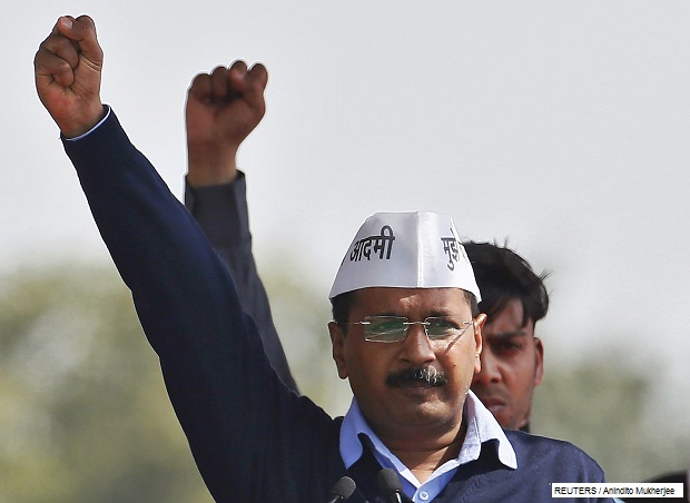Kejriwal, chief of AAP shouts slogans after taking the oath as the new chief minister of Delhi during a swearing-in ceremony at Ramlila ground in New Delhi